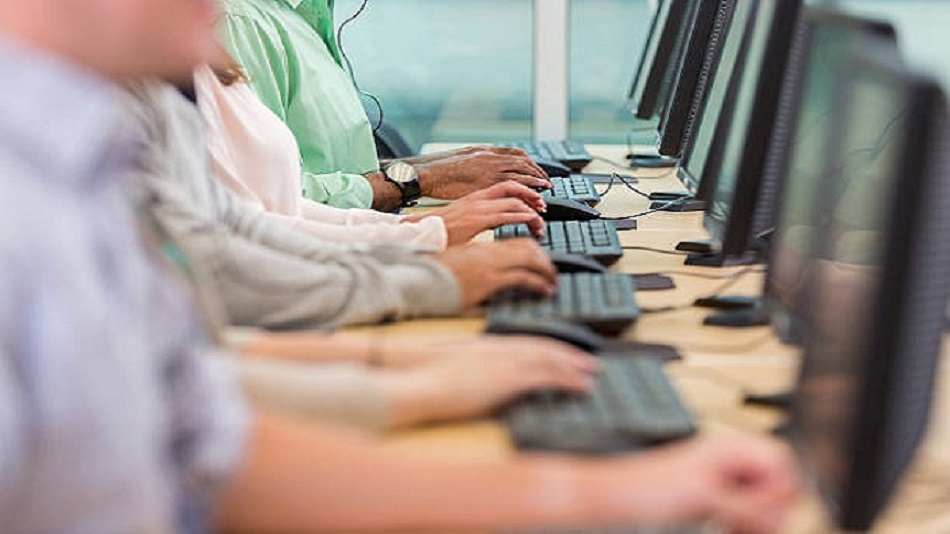 personnes diverses tapant sur des claviers tout en travaillant dans un centre d'appels - service client externalisé - Optiserv